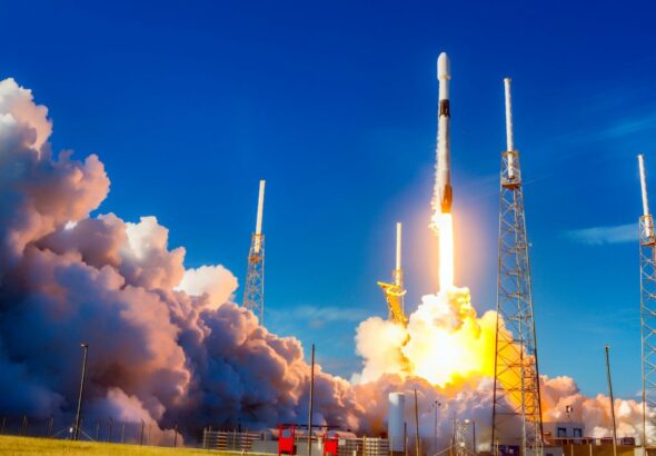 white and red space ship on blue sky during daytime