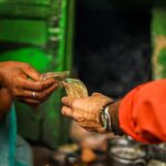 a person handing money to another person