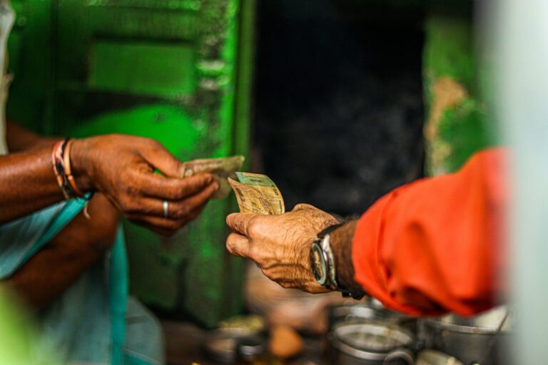 a person handing money to another person