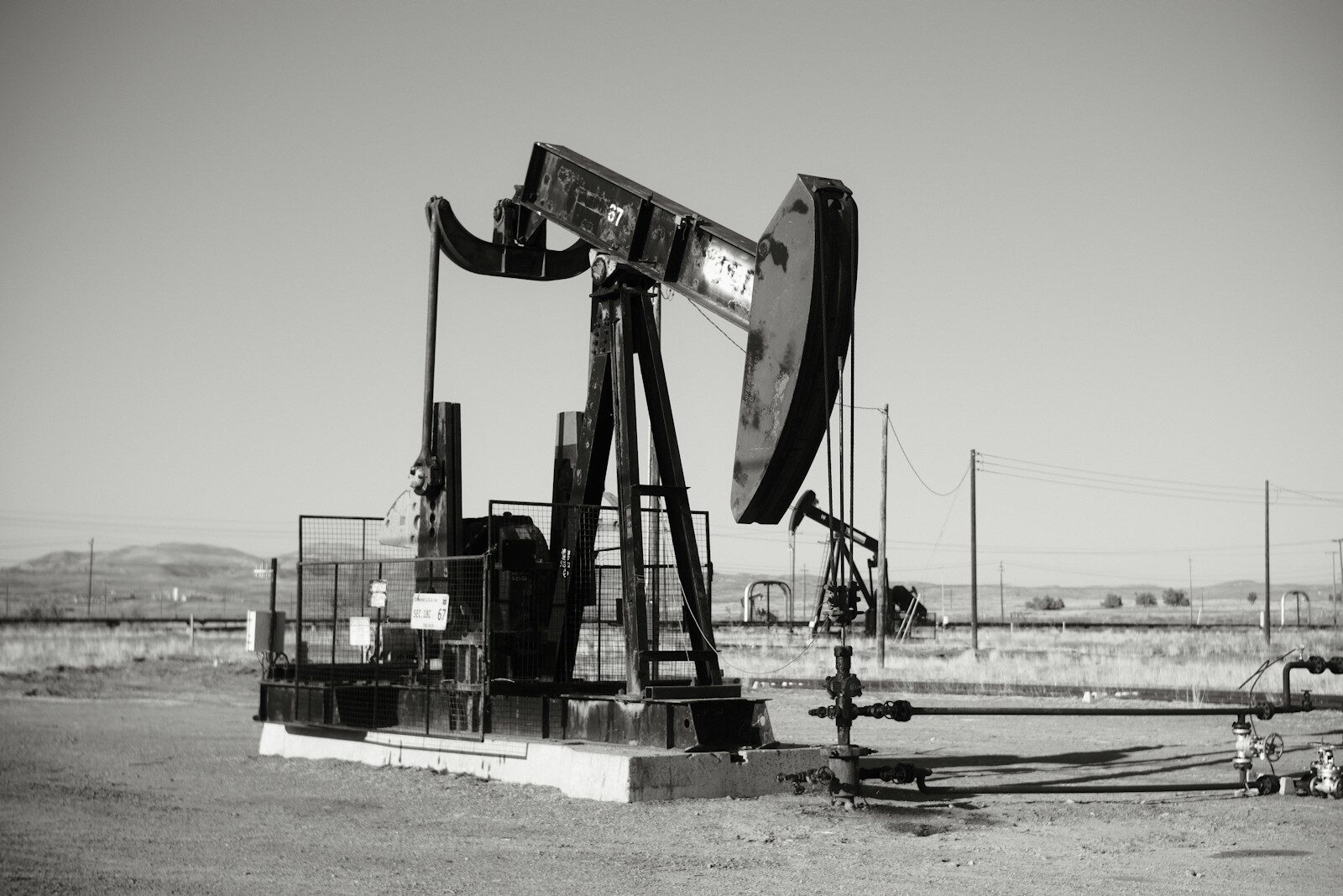 a black and white photo of an oil pump