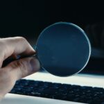 person holding round blue frame