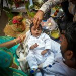 A cultural baby blessing ceremony with family, showcasing rich traditions and rituals.