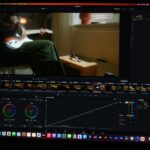 a computer screen showing a man sitting in a chair